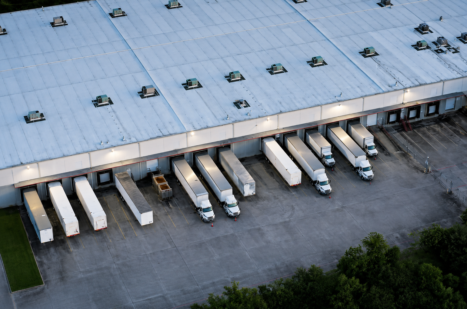 Transportation logistics warehouse with trucks at loading docks
